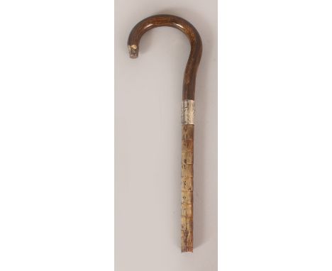 A HORN HANDLE, possibly rhinoceros horn, with a hallmarked silver collar and part of a stick attached, the handle itself 4in(