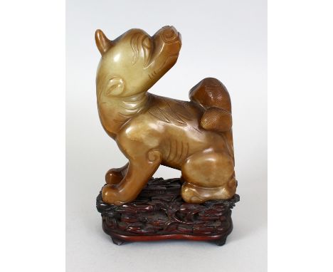 A 17TH CENTURY CHINESE LATE MING DYNASTY JADE MODEL OF A BUDDHISTIC LION, together with a good quality fitted carved hardwood