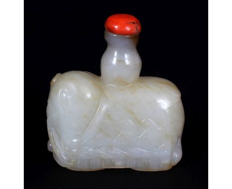 A CHINESE WHITE JADE SNUFF BOTTLE OF A STANDING CAPARISONED ELEPHANT, together with a coral stopper, the saddle cloths carved