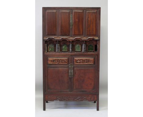 A CHINESE HARDWOOD CABINET, with two doors opening above an unusual mirrored gallery fitted with four glass fronted and calli