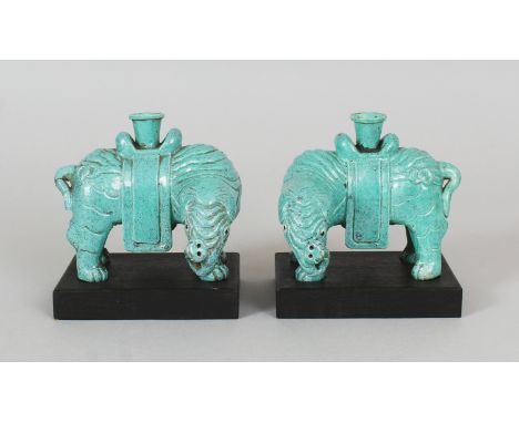 A MIRROR PAIR OF 18TH/19TH CENTURY CHINESE ROBIN'S EGG ELEPHANT CANDLE OR JOSS STICK HOLDERS, together with fitted wood stand