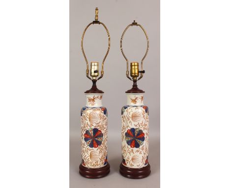A PAIR OF EARLY 18TH CENTURY CHINESE IMARI KANGXI PERIOD PORCELAIN ROULEAU VASES, fitted for electricity, the sides painted i