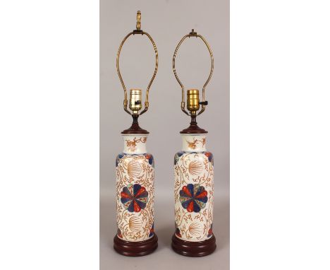 A PAIR OF EARLY 18TH CENTURY CHINESE IMARI KANGXI PERIOD PORCELAIN ROULEAU VASES, fitted for electricity, the sides painted i