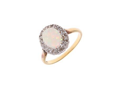 the oval-shaped solid white opal is set within a surround of circular-cut diamonds, in 18ct gold, 3.5 grams. Size M 1/2.   *C