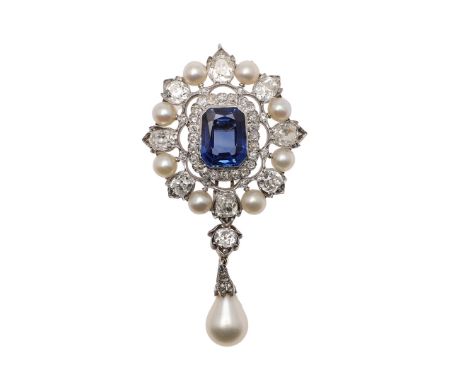 the octagonal-shaped sapphire is set within a surround of cushion-shaped diamonds, within an outer surround of natural pearls