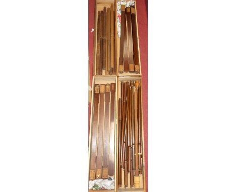 A collection of stick barometer frames in four boxes