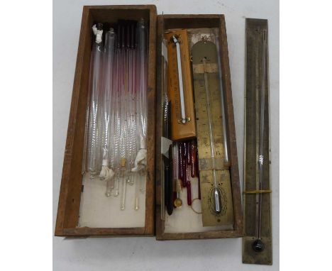 A collection of thermometer tubes, storm bottles, and scales