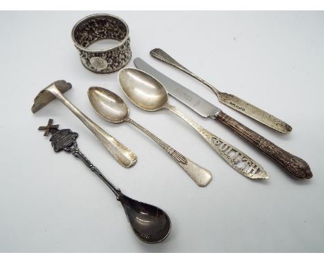 A collection of silver and white metal items to include hallmarked napkin ring, silver handled knife, spoon stamped 'Sterling