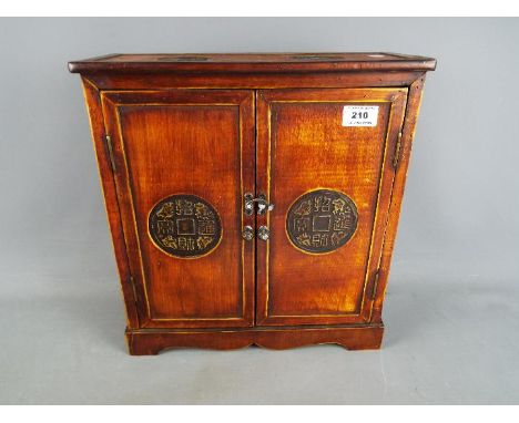 A small two-door cupboard of Asian decoration, approx 36.5 cm (h) x 34 cm (w) x 13 cm (d)