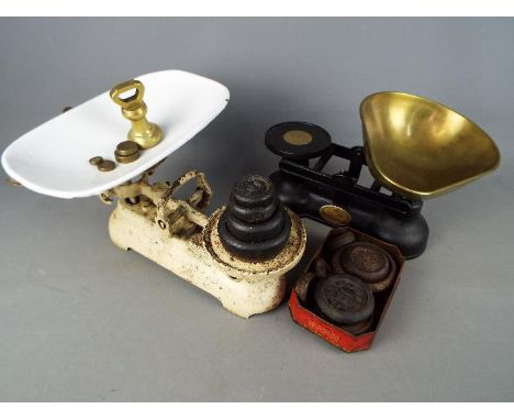 A vintage set of kitchen scales with wights and one other.