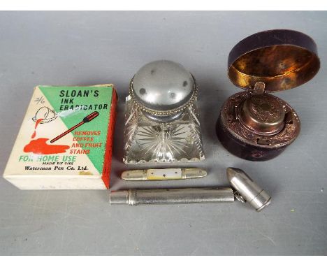 A lot to include three inkwells, one cut glass example, a leather bound travelling inkwell and a further novelty travelling e