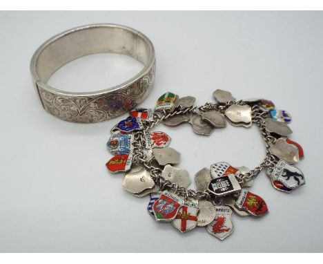 A German silver charm bracelet, stamped 835, with a good amount of town crest charms, variously stamped 800, 835 etc and a ba