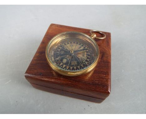 A brass compass marked 'Royal Navy' in box.