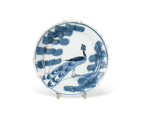 A Bristol delft blue and white 'farmyard' plate, circa 1740,decorated with a peacock and trees, 20cm diameterCondition report