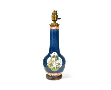 A Sampson porcelain gilt metal mounted bottle vase, in Kangxi style,the powder blue ground reserved with two shaped panels de