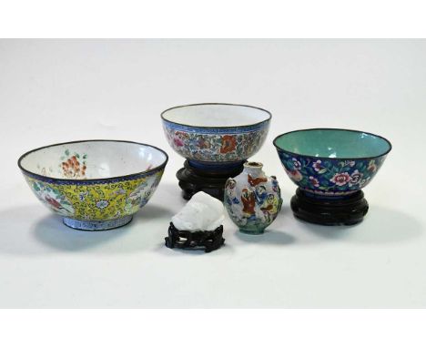 A Chinese enamel floral bowl, Qing Dynasty, late 18th/early 19th century,finely painted with butterflies amongst scrolling pl