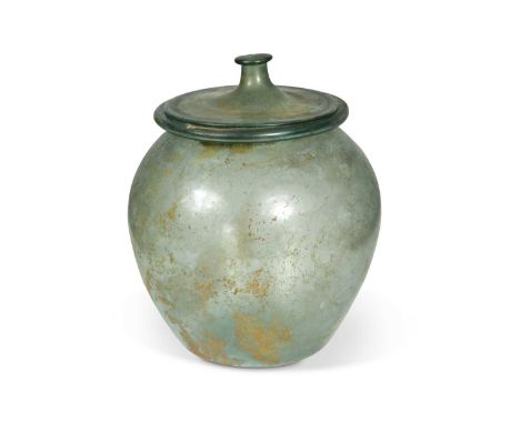 A Roman blue-green glass cinerary urn and cover, 1st-2nd century AD,with disk shaped cover with knopped finial, 21cm highFoot