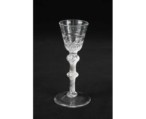 A rare George II air twist wine glass, circa 1750,the round funnel bowl moulded with a lower girdle of trailing flowers and g