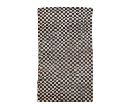 A Tibetan rug,of black and white 'chequerboard' design173 x 89cmCondition report: Low pile to central area Numerous reweaving