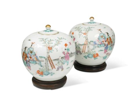 A pair of Chinese famille rose porcelain ovoid vases and covers, late Qing Dynasty,painted with mothers and children playing 