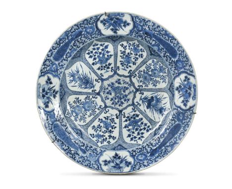 A Chinese blue and white porcelain peacock charger, Qing Dynasty, Kangxi (1662-1722)with central eight petalled medallion wit