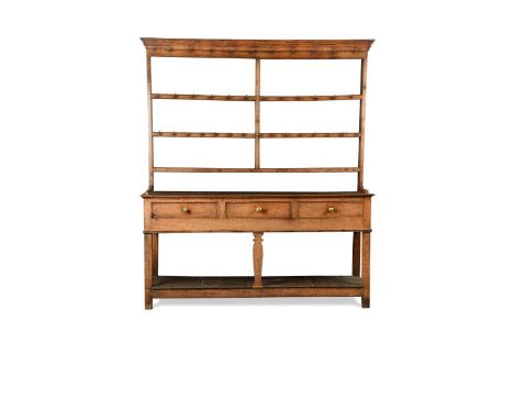 A George III dresser,the open three shelf back above three frieze drawers supported on a central silhoutte leg, flanked by sq