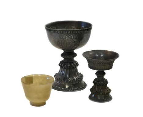 A Tibetan silver yak butter lamp, late 19th/early 20th century,cast and chased with petallate ribs and fringes, 10.cm high, w