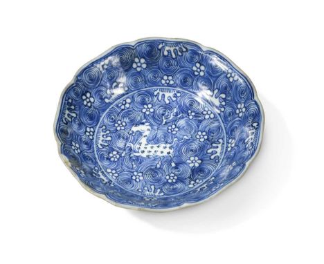 A Chinese blue and white porcelain dish, Qing Dynasty, Kangxi (1662-1722),of barbed circular shape, painted with a horse amon