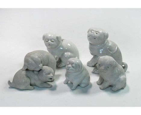 A group of five Japanese porcelain puppy and puppy groups, 19th/20th century,in playing and seated poses, largest 13.5cm high