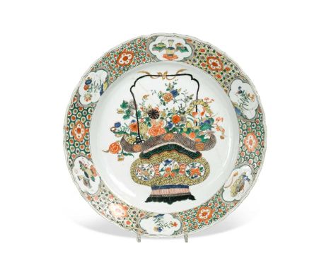 A Chinese famille verte porcelain dish, Qing Dynasty, Kangxi (1662-1722),barbed circular, painted with a basket of flowers wi