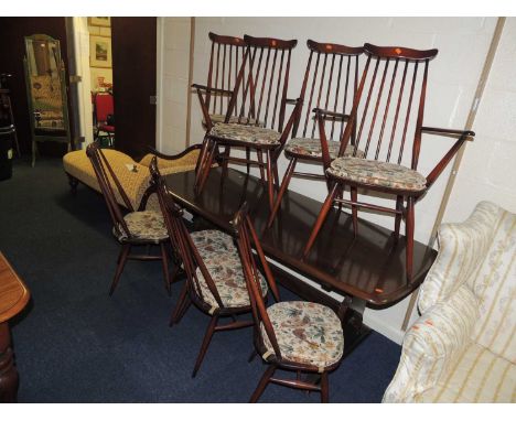 ERCOL DARK STAINED DINING SUITE, comprising dining table 80 x 180cms, and set of eight stick back dining chairs (9)Provenance