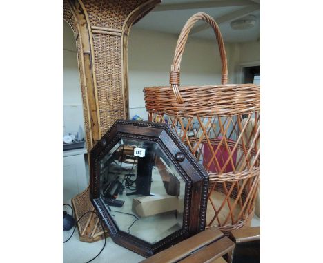 GEORGE V OAK OCTAGONAL BEVEL GLASS WALL MIRROR, 41cms, along with a rattan jardiniere stand, and wicker log basket (3)Provena