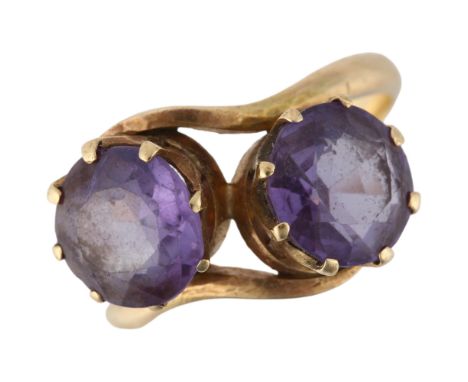 A late 20th century two stone synthetic sapphire crossover ring, claw set with 8.5mm sapphires, apparently unmarked, size O, 