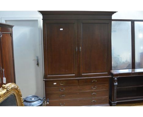 A George III mahogany linen press, the top with moulded cornice above a pair of doors with arched inlay, the base with two sh
