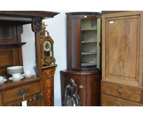 A George III inlaid mahogany bowfronted standing corner cupboard, the upper section with moulded cornice above a pair of stri