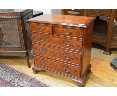 A George II style burr walnut and elm chest of drawers, the quarter veneered, crossbanded, moulded rectangular top over two s