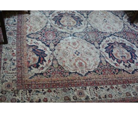 An Indo-Persian small carpet, the centre panel with allover interlocking scalloped floral medallions with lotus flower and le