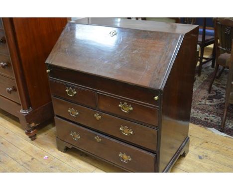 A George III mahogany bureau, the slant front opening to an attractively fitted interior, with a well beneath a slide, above 