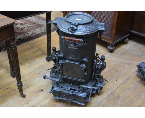 A French cast-iron portable stove, c. 1870, Choubersky, Paris, of cylindrical form, the hinged cover cast with scrolling foli