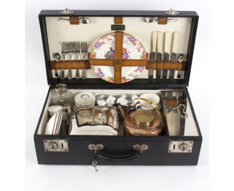 A Coracle motoring hamper, fitted with plates, cups, saucers, kettle, sandwich box etc.   Condition Report:  There appears to