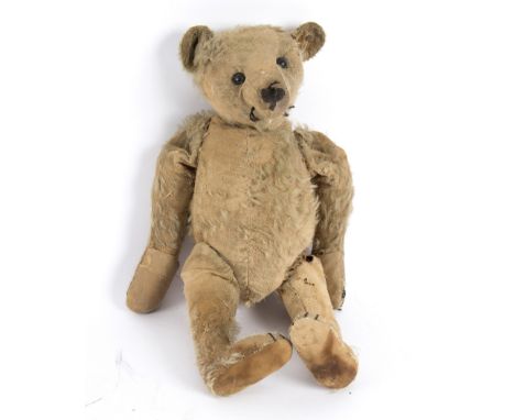 A Steiff teddy bear with jointed limbs and blonde fur, button to ear, a/f, approximately 36cm long