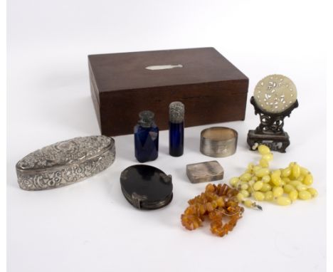 A Victorian silver repoussé decorated oval box, a small silver pill box, a silver napkin ring, a tortoiseshell mounted magnif