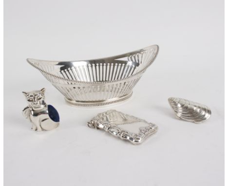 A Dutch silver bowl of navette shape with beaded rim and pierced sides, 18cm long, a sterling silver cat pin cushion, a white