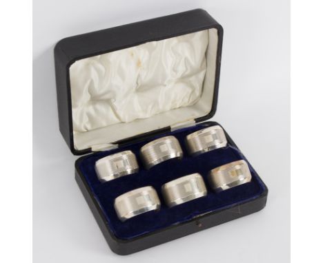 A set of six silver napkin rings, GUS & L, Birmingham 1931, with engine turned decoration, in fitted caseapproximately 265gm