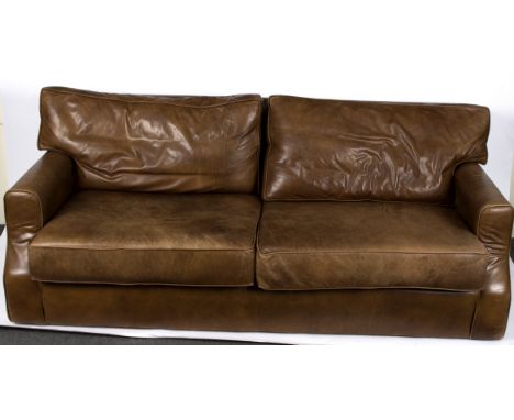 A modern brown leather three seater sofa