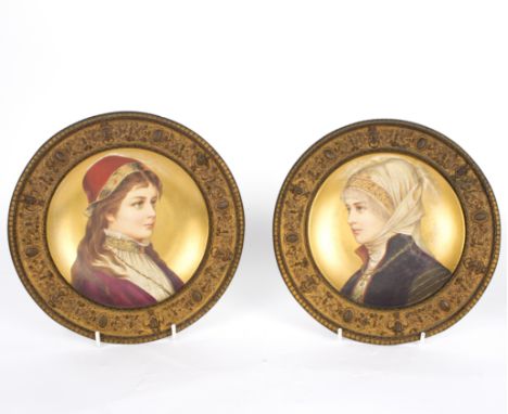 A pair of German gilt-ground cabinet plates, circa 1870, each painted a portrait of a maiden in historical dress, mounted in 