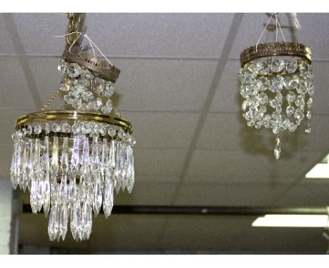 A three-light pendant ceiling light hung prismatic drops, two others and a pair of two-branch wall lights