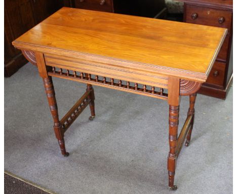 A late Victorian fold-over card table with galleried frieze, on turned legs, 92cm wide