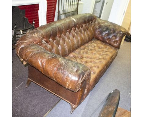 A late 19th Century upholstered sofa with leather buttoned upholstery, on turned front legs, 218cm wide