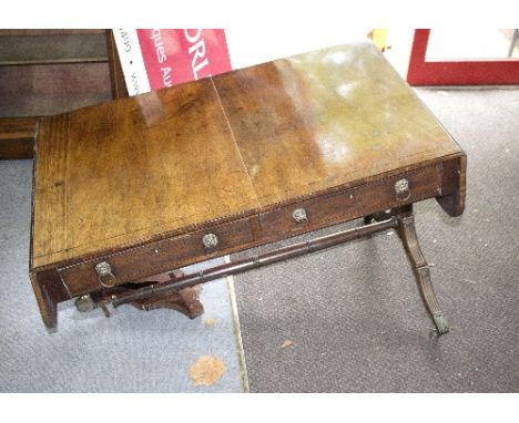 A Regency mahogany sofa table, fitted two-drawers on reeded outswept legs, 148cm wide flaps up (damages)